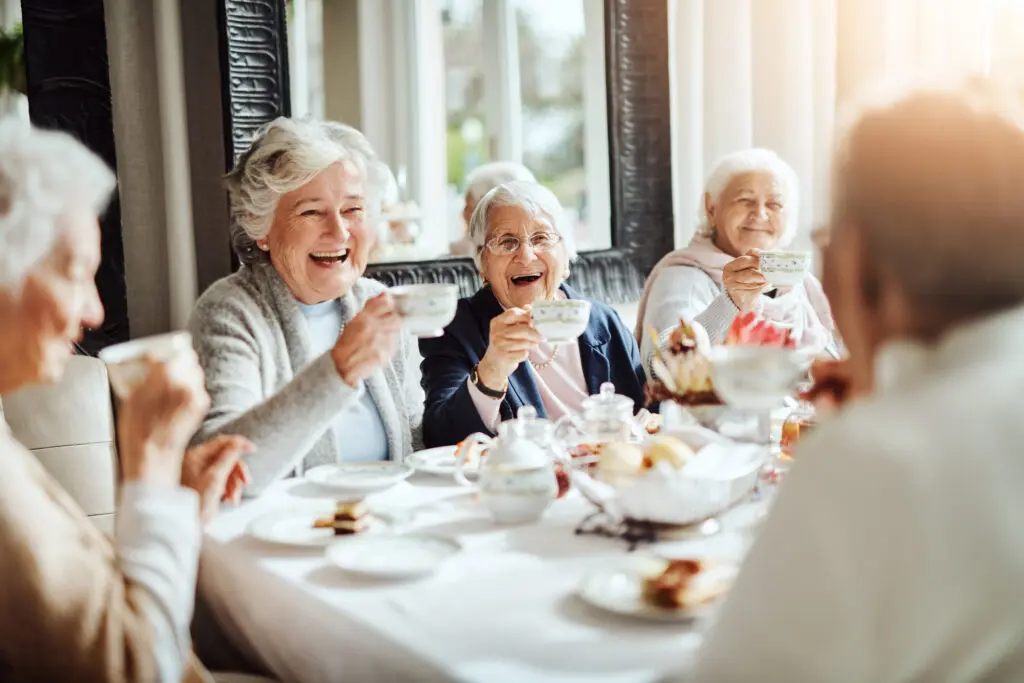 Group of senior women at a tea party smiling