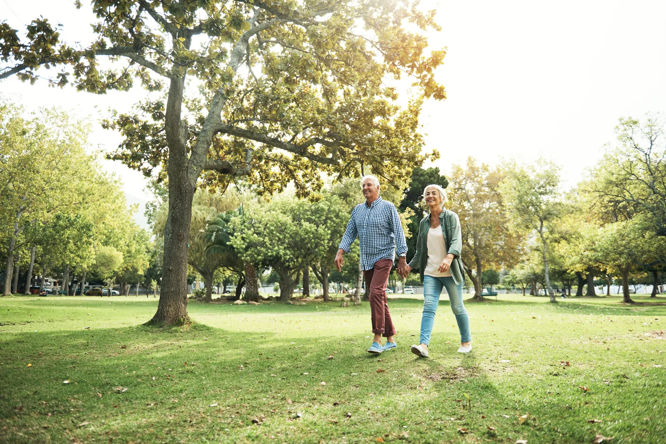 Two seniors walking outside while discussing residents' favorite services and amenities at Sedgebrook in Lincolnshire, IL.