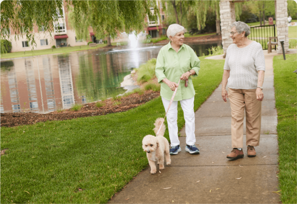 seniors on a walk at Sedgebrook with their dog