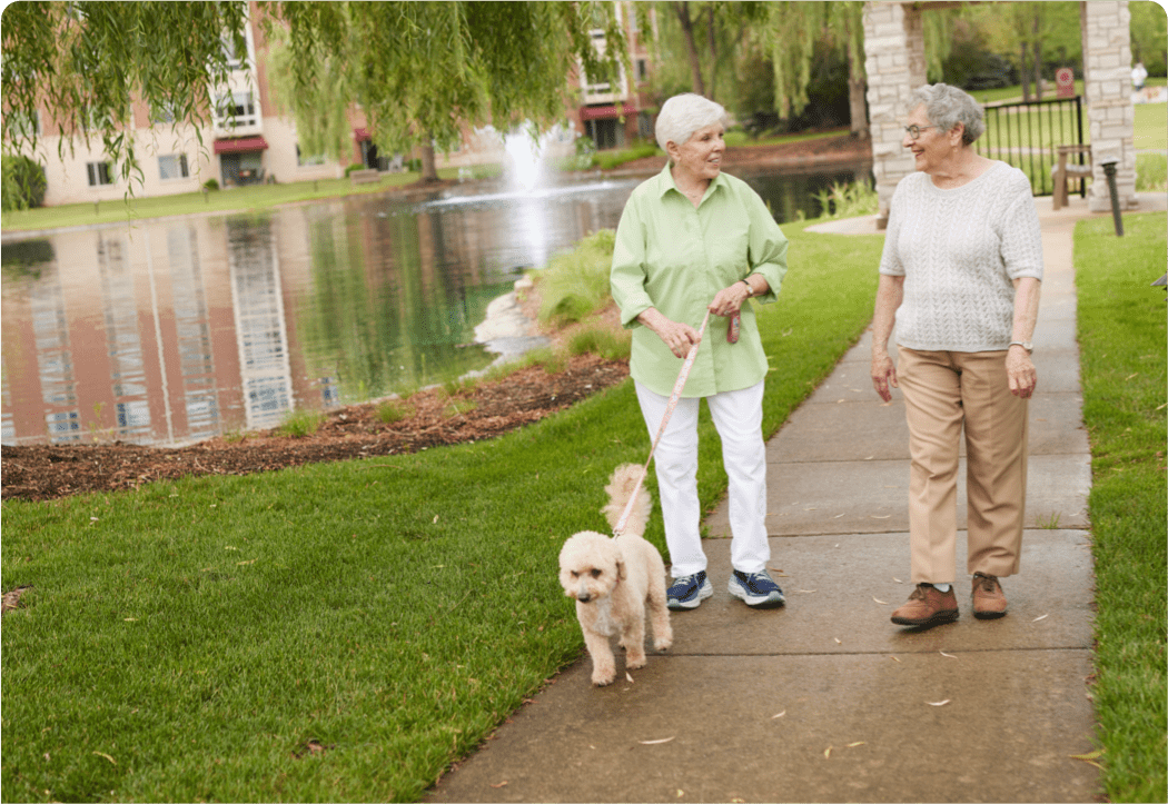 seniors on a walk at Sedgebrook with their dog