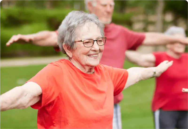 Seniors doing tai chi outside