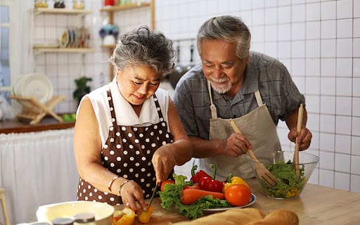 senior couple cooking together at home