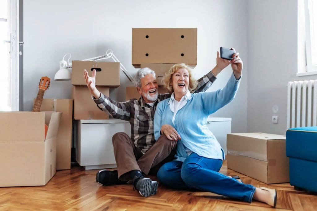 Senior couple taking a selfie after packing