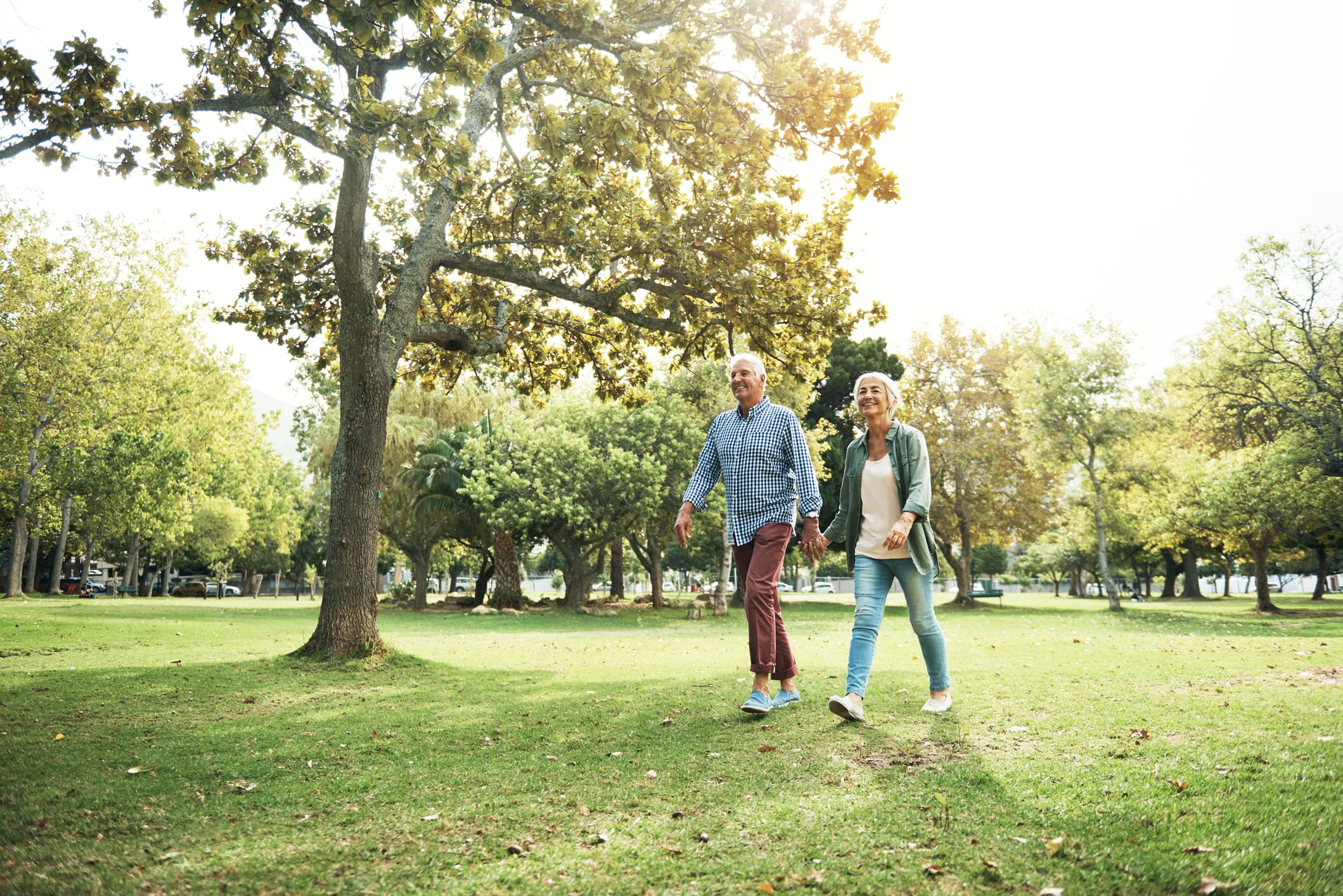 Two seniors walking outside while discussing residents' favorite services and amenities at Sedgebrook in Lincolnshire, IL.