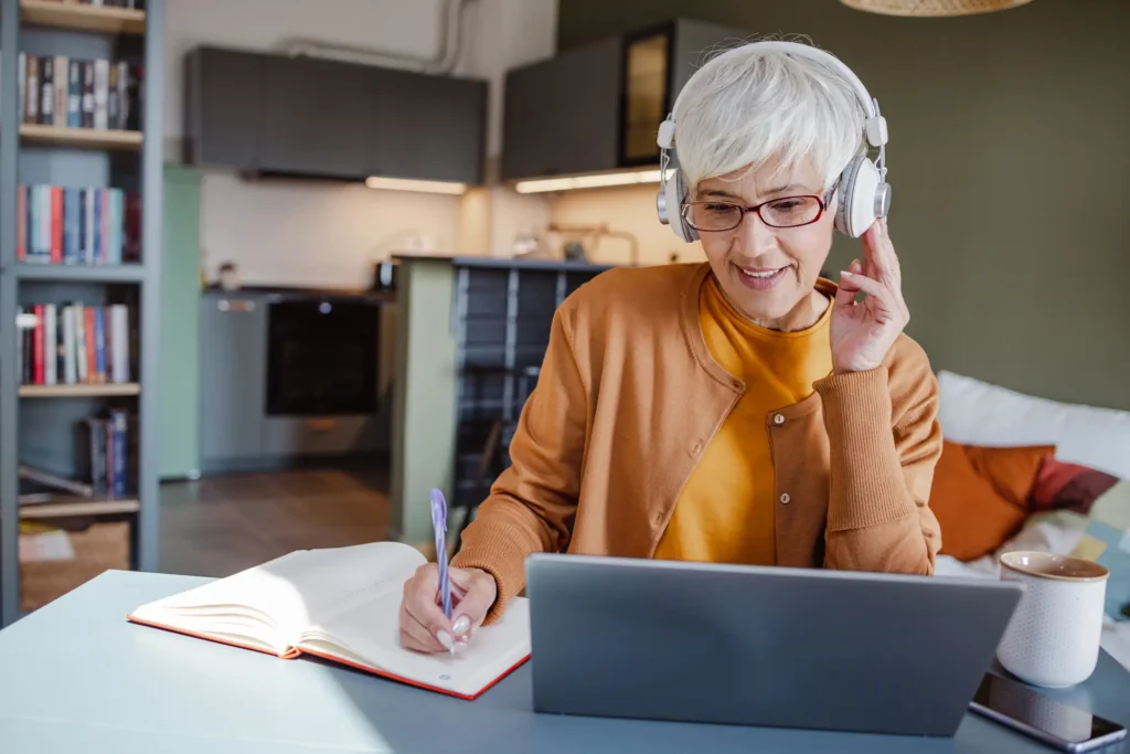 fashionable senior woman takes an online course from the comfort of her home in Sedgebrook in Lincolnshire, IL.