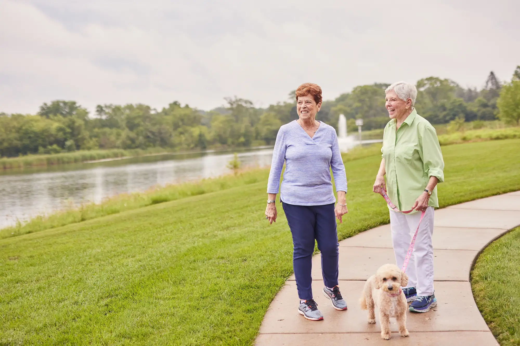 Residents at Sedgebrook In Lincolnshire, IL exploring the health benefits of outdoor activities for seniors by walking a dog