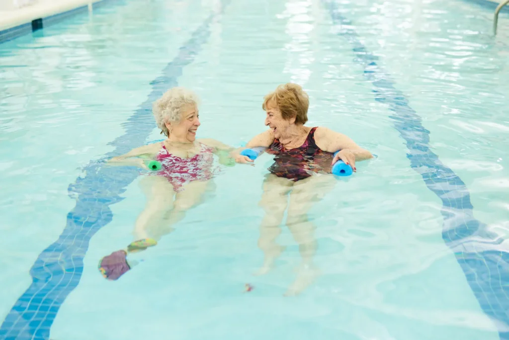 senior women at Sedgebrook in pool, smiling because they looked into the best retirement plans for individuals in Lincolnshire, IL.