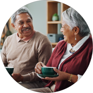 Caretaker and Elderly woman laughing while walking