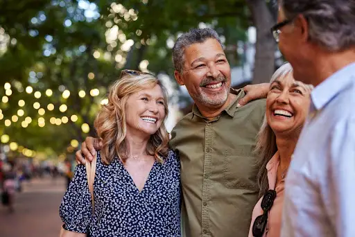 senior living options for independent living communities in Illinois 1 2 senior couples hugging and talking about senior living options for independent living communities to plan ahead for retirement in Illinois